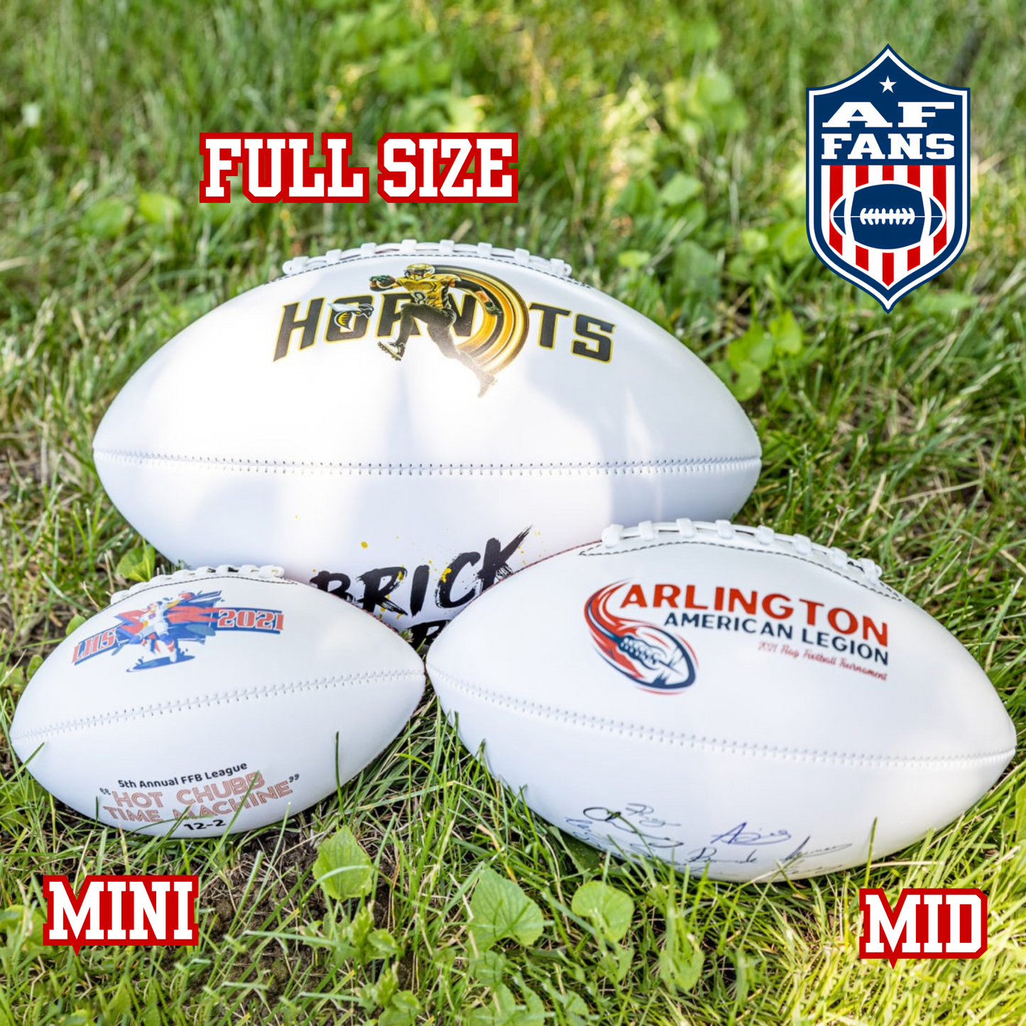 A personalized white football with blue and red text that includes three text lines and a date, displayed on a black stand.